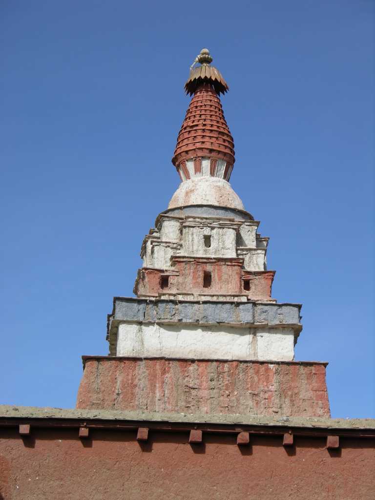 Tibet Guge 03 Tholing 17 Yeshe O Chorten Towering above each of the four corners of Yeshe O's Mandala Chapel complex are the only stupas of the Indian prasada style in existence. They are also uncommon in being made up of terracotta, since most Tibetan stupas are made from mud and stone.